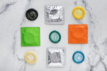 Obraz na płótnie Canvas Wrapped and open condoms on light background