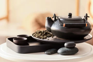 Foto op Aluminium Modern teapot, cups and dry green tea on table © Pixel-Shot