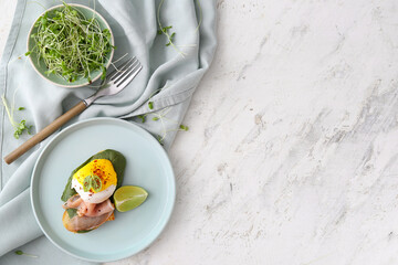 Tasty sandwich with florentine egg, bacon and lime on light background