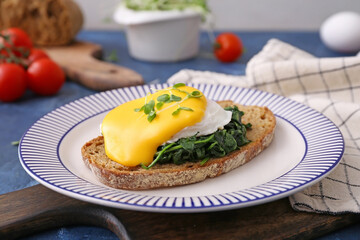 Tasty sandwich with florentine egg on color background, closeup
