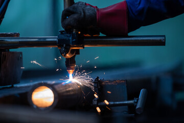 Plasma cutting of the pipe. the operator cuts with a plasma torch