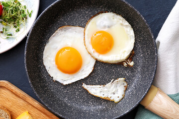 Creative breakfast for children with eggs on dark background, closeup
