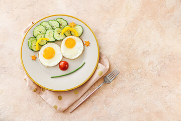 Creative breakfast for children with eggs and fresh vegetables on color background