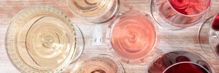 Wine panorama with different types of wine, a flat lay on a wooden background