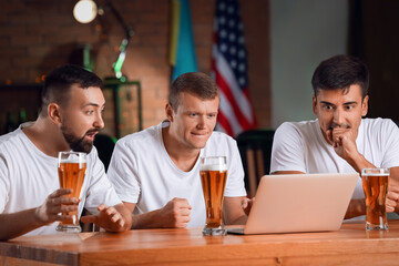 Men placing sports bet in pub