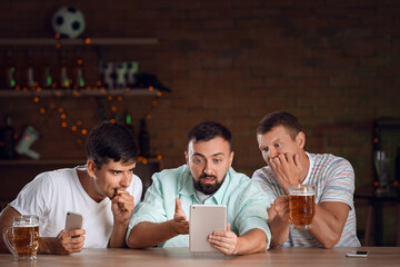 Men placing sports bet in pub