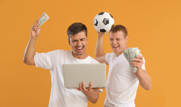 Happy men after winning of their sports bet on color background