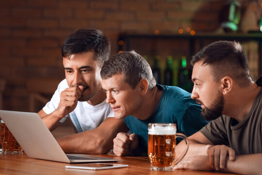 Men placing sports bet in pub