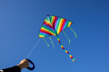 Girl flying kite in blue sky