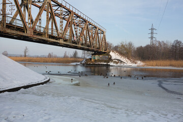 City Riga, Latvia. Old railway bridge and river in winter.Travel photo