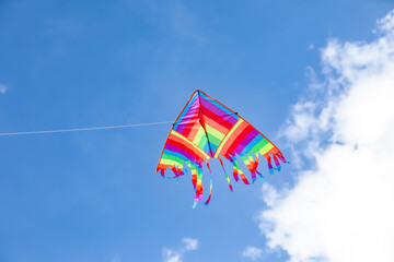 Colorful kite flying in blue sky