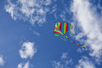 Colorful kite flying in blue sky