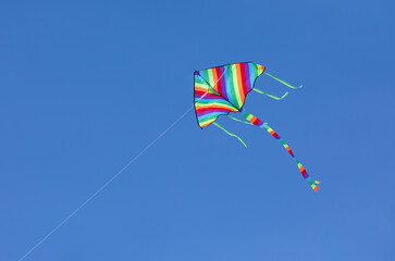 Colorful kite flying in blue sky