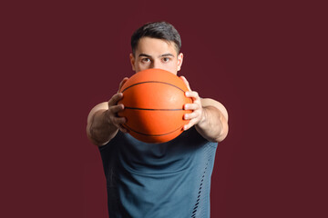 Male basketball player on dark color background