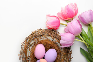 Beautiful Easter composition with eggs and spring flowers on white background