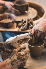 Potter's wheel. Working with clay. Potter's hands.