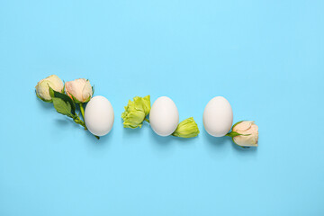 Beautiful Easter composition with eggs and spring flowers on color background