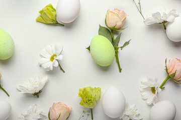 Beautiful Easter composition with eggs and spring flowers on white background