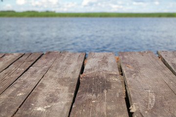 Wooden platform over pond on summer day