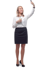 young woman in formal wear with takeaway coffee taking a selfie.