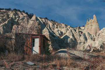 cabin in front of a rock formation in the desert of cappadocia
