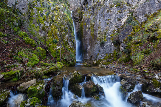 Beautiful and elevated waterfall between the rocks in the Arroyo de Arbalejos, Cabornera, León, Spain.