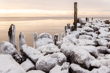 Tuja coast of Vidzeme sea shore Rīgas jūras līcis Gulf of Riga winter violet sunset rock formation path frozen water on wooden sticks