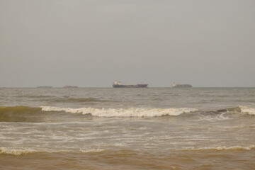 A beautiful view of sea waves and ship in the background  