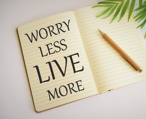 Word writing text Live More Worry Less in Notebook. Business concept for Have a good attitude motivation be careless enjoy life