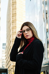 Woman looking to the camera outdoors.