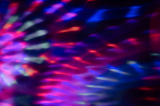 Blur colorful neon light leaks on black background. Defocused illuminated abstract futuristic texture for using over photos as overlay or screen filter