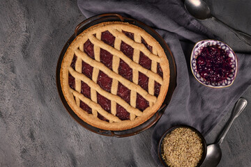 Top view of homemade pie called 'Linzer Torte', a traditional Austrian shortcake pastry topped with...