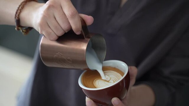 Barista pouring Swan beautiful Latte art in coffee cups at cafe footage video 4k
