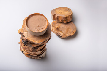Cup of coffee on cross sections of tree.