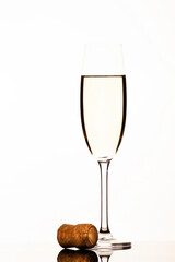 Champagne glass and cork in white backround