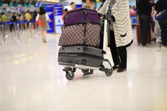 Passenger with baggage or suitcase in hall of airport