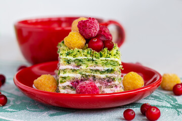 sweet layer cake with spinach and cream decorated with fresh berries, healthy nutrition, diet breakfast