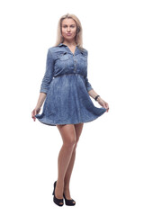 thoughtful young woman in a denim dress looking at a white screen.