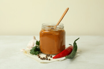 Jar with zucchini caviar on white textured table