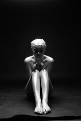 Obraz premium Young fit athletic woman in silver body paint posing