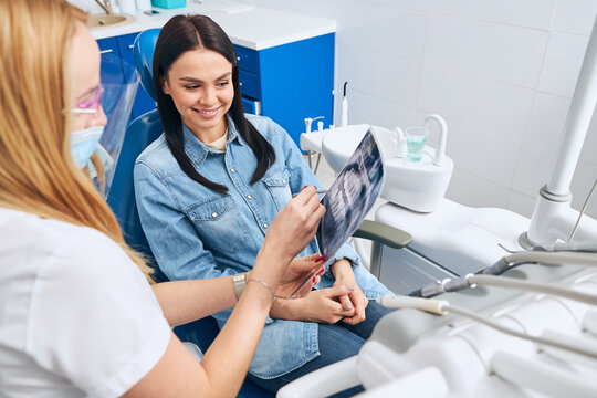 Young female visiting dentist in modern clinic