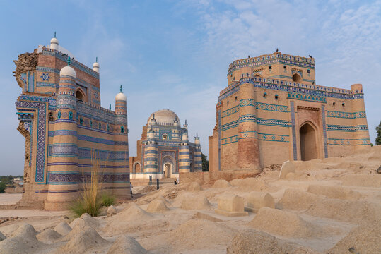 Landscape View Of Beautiful Ancient Medieval Islamic Architecture With Tomb Of Bibi Jawindi In Middle And Traditional Graveyard In Foreground In Uch Sharif, Bahawalpur, Punjab, Pakistan