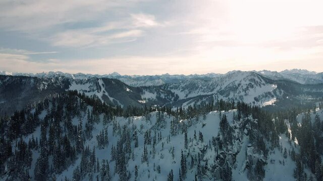 Breathtaking Aerial View Flying Over Mountain Ridge Revealing Ski and Snowboard Resort