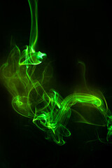 Green smoke motion on black background.