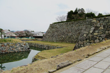 Fototapeta na wymiar 篠山城跡／Stone wall and moat at the site of Sasayama Castle / Sasayama City, Hyogo Prefecture, Japan
