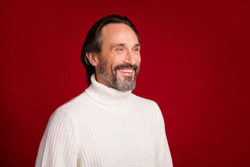 Photo of mature handsome cheerful positive smiling man in white turtleneck look copyspace isolated on red color background
