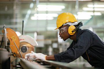 Engineering male african american workers wear soundproof headphones and yellow helmet standing...