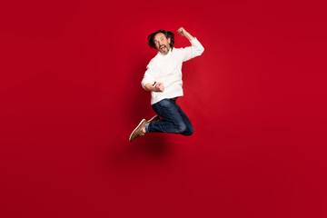 Full length body size photo of crazy aged man jumping high lucky lottery winner isolated on red color background