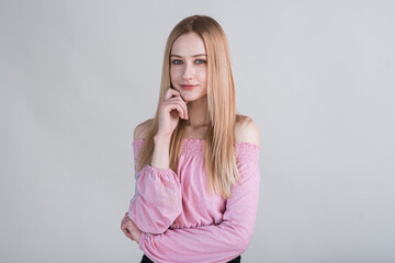 Portrait of a blonde girl who made a pensive look in the studio on a white background