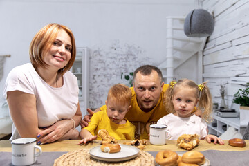 Happy young family having fun together on a Sunday morning having breakfast